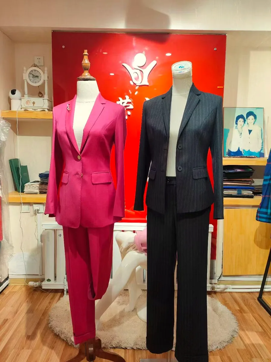 Two tailored suits on dress forms in the shop